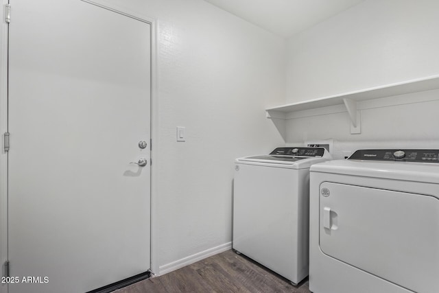 clothes washing area featuring dark wood-type flooring and washing machine and clothes dryer