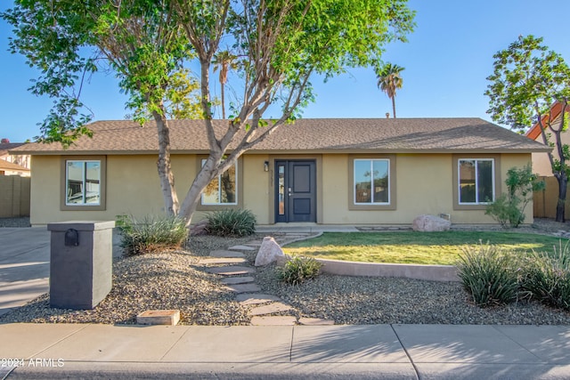 ranch-style house with a front yard