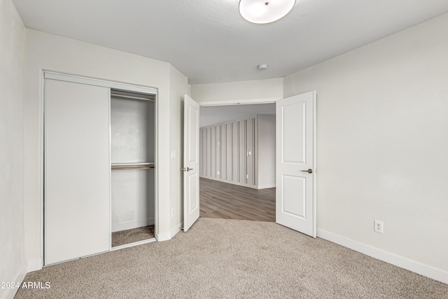 unfurnished bedroom with a closet and carpet floors