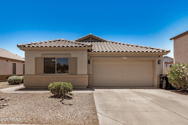 11531 E Persimmon Ave, Mesa, AZ 85212 - view of front facade featuring a tiled roof, a garage, stucco siding, and driveway