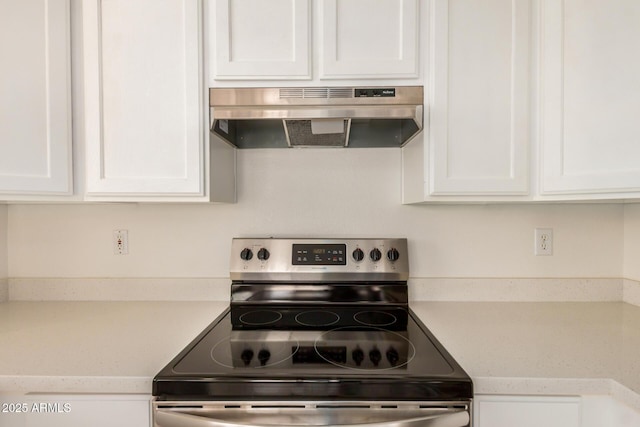 11531 E Persimmon Ave, Mesa, AZ 85212 - kitchen with stainless steel electric range oven, under cabinet range hood, white cabinetry, and light countertops