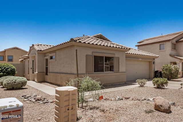 11531 E Persimmon Ave, Mesa, AZ 85212 - view of front facade featuring a garage, a tiled roof, stucco siding, and concrete driveway