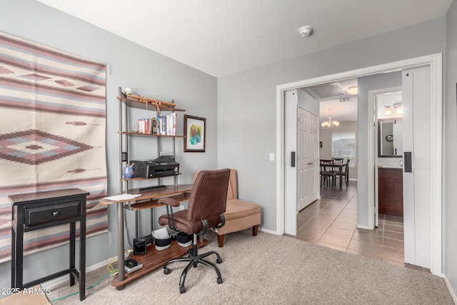 home office with light carpet and a notable chandelier