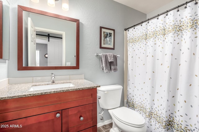 bathroom featuring vanity, a shower with curtain, and toilet