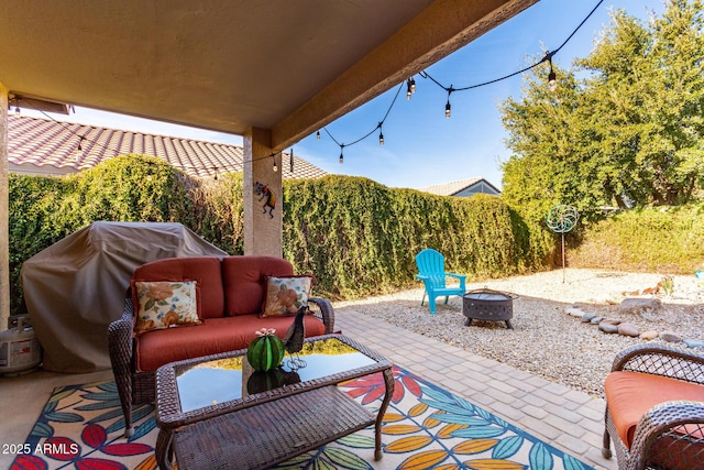 view of patio / terrace featuring area for grilling and an outdoor living space with a fire pit