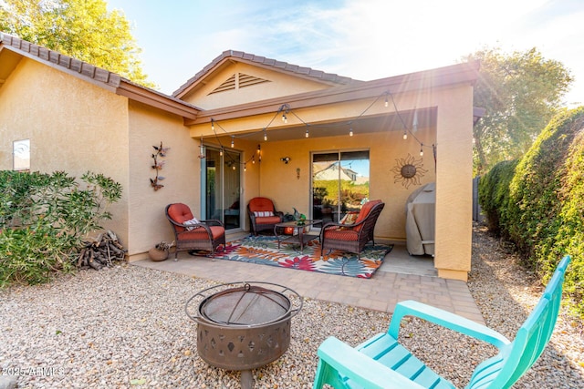 view of patio / terrace featuring an outdoor living space with a fire pit