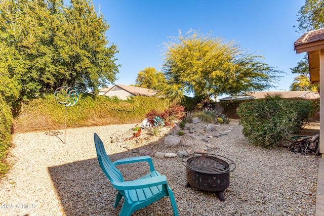 view of yard featuring an outdoor fire pit