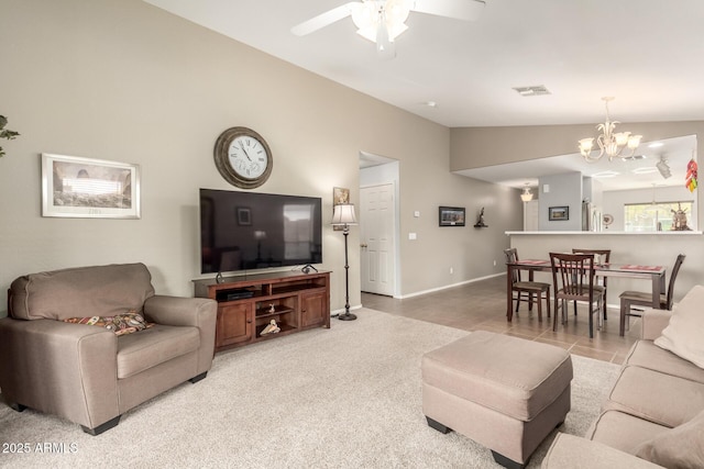 living room with lofted ceiling and ceiling fan with notable chandelier