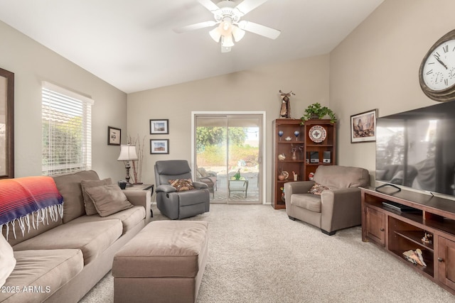 living room with ceiling fan, lofted ceiling, plenty of natural light, and light carpet