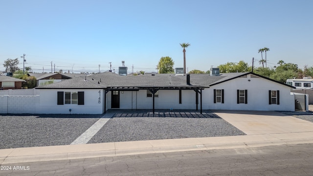 ranch-style home with a patio and central AC unit