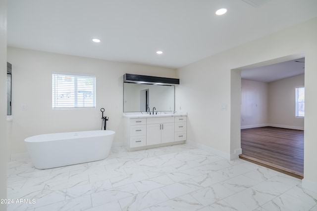 bathroom featuring a bathtub, vanity, and hardwood / wood-style flooring