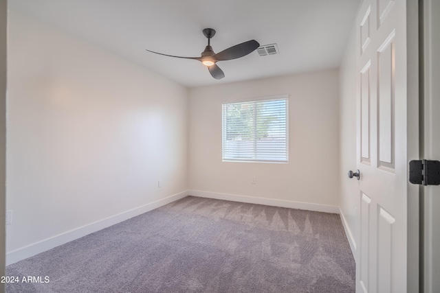 spare room featuring ceiling fan and carpet flooring