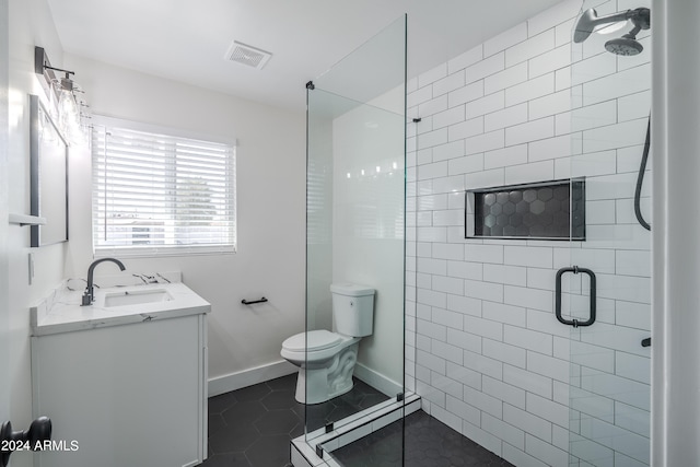 bathroom with tile patterned floors, walk in shower, vanity, and toilet