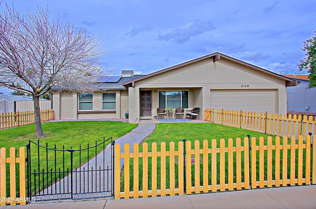 ranch-style home with a front yard, a gate, a garage, a fenced front yard, and roof mounted solar panels