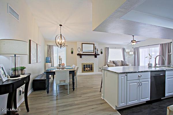 kitchen with stainless steel dishwasher, visible vents, a wealth of natural light, and a sink