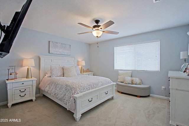 bedroom with ceiling fan, baseboards, and light carpet