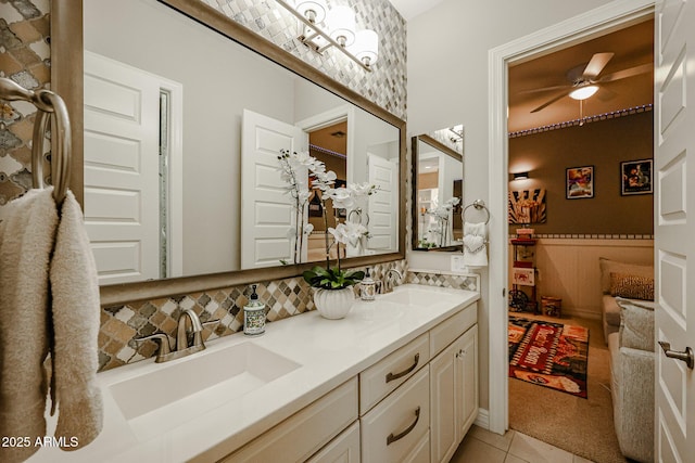 bathroom featuring ceiling fan, tile patterned floors, vanity, and tasteful backsplash