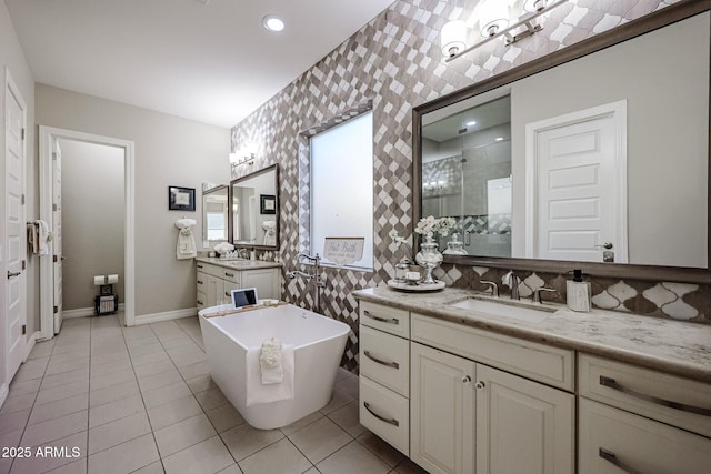 bathroom with vanity, tile patterned flooring, and plus walk in shower