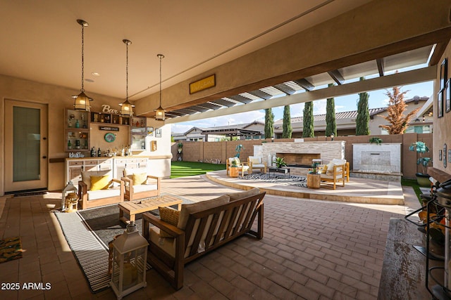 view of patio / terrace featuring an outdoor stone fireplace