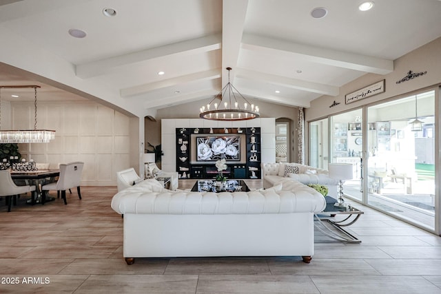 living room featuring vaulted ceiling with beams and an inviting chandelier