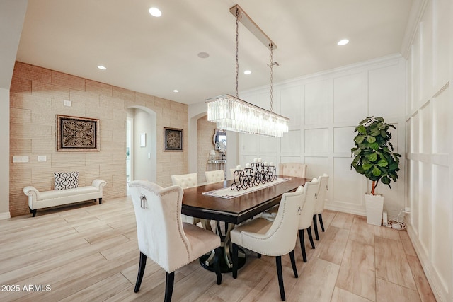 dining area featuring light hardwood / wood-style floors and crown molding