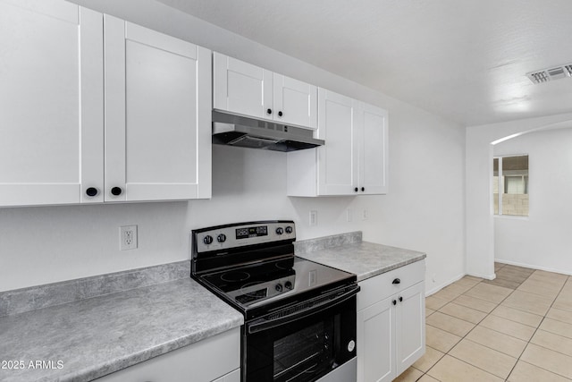 kitchen featuring under cabinet range hood, white cabinetry, visible vents, light countertops, and stainless steel electric range oven