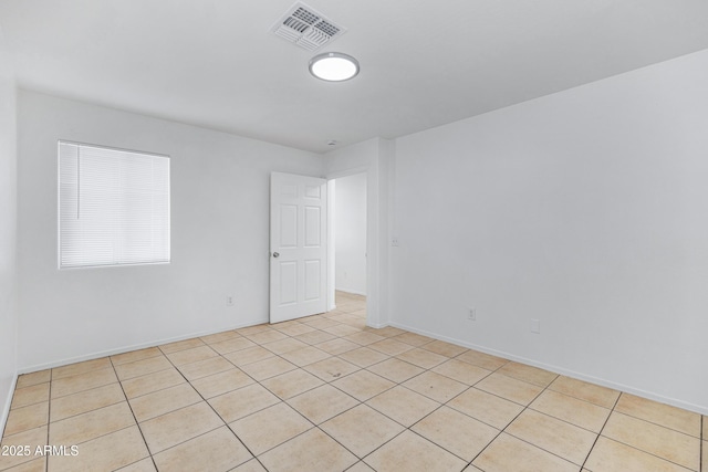 empty room featuring visible vents and baseboards