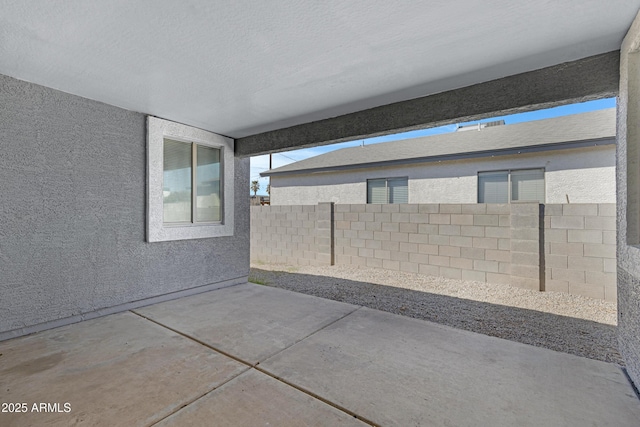 view of patio featuring fence