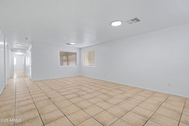 empty room with visible vents and baseboards