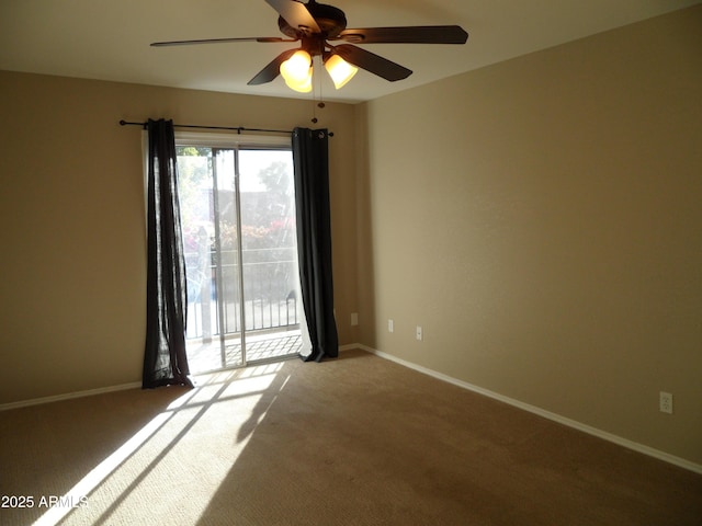 spare room with carpet floors and ceiling fan