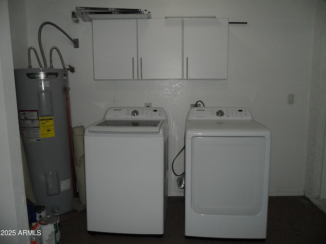 laundry area featuring washer and dryer, cabinets, and electric water heater