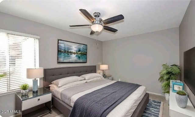 bedroom with ceiling fan and multiple windows