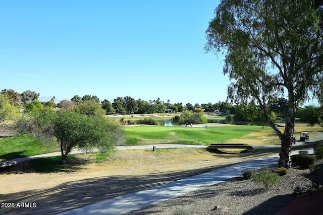 surrounding community with a lawn and a water view