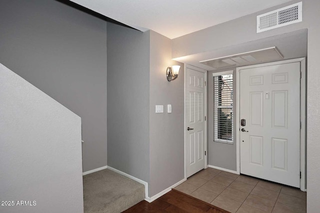 foyer featuring light tile patterned floors