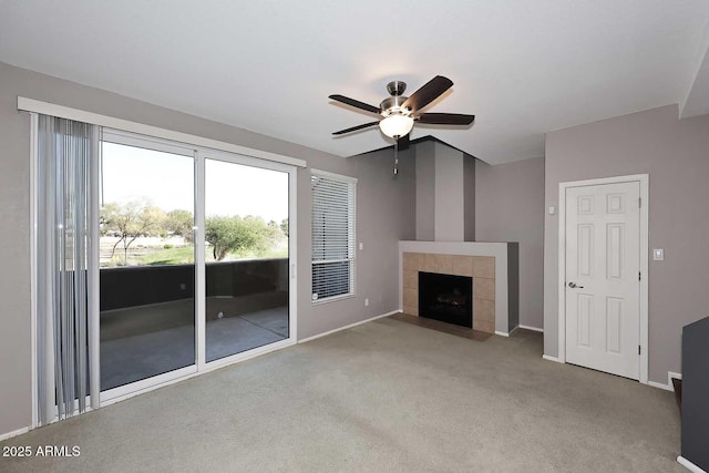 unfurnished living room featuring ceiling fan, carpet flooring, and a fireplace