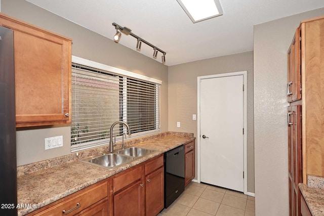 kitchen with light tile patterned flooring, rail lighting, dishwasher, and sink