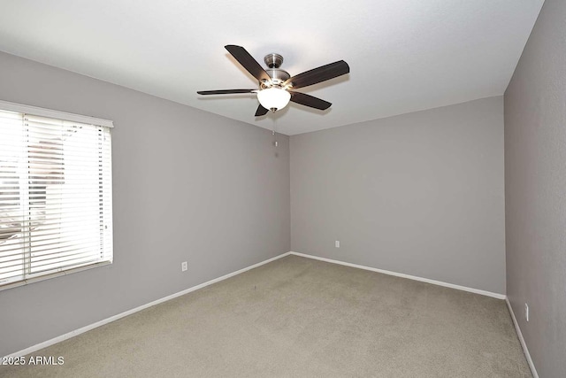 spare room with light carpet and ceiling fan