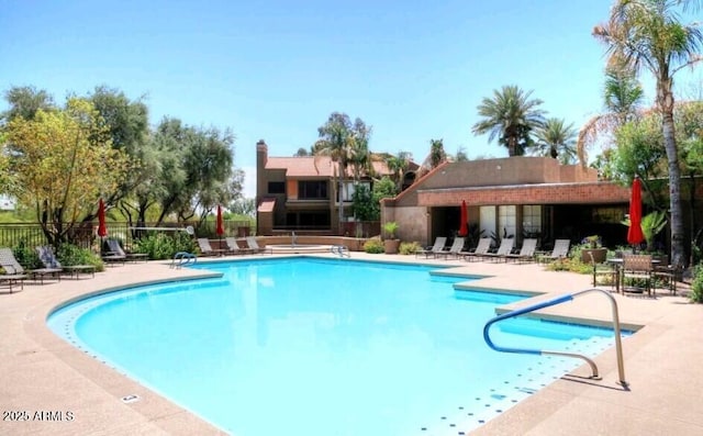 view of swimming pool with a patio