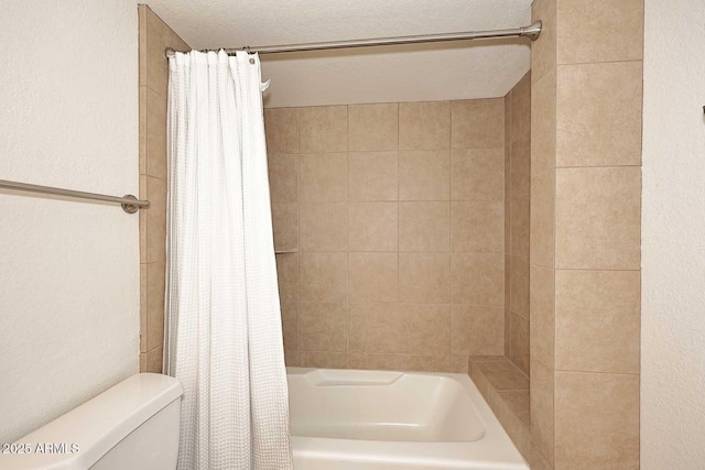 bathroom with toilet, shower / tub combo, and a textured ceiling