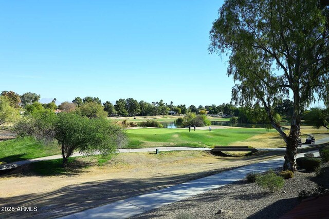 surrounding community with a lawn and a water view