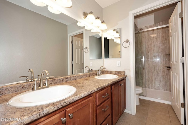 bathroom featuring tiled shower, tile patterned floors, toilet, and vanity