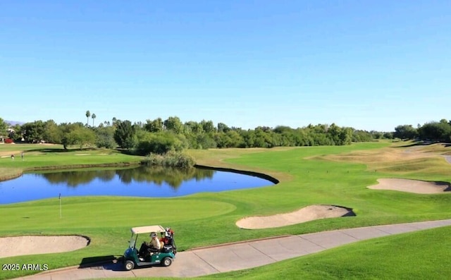 surrounding community featuring a water view and a lawn