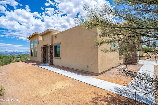 view of property exterior featuring stucco siding and a patio