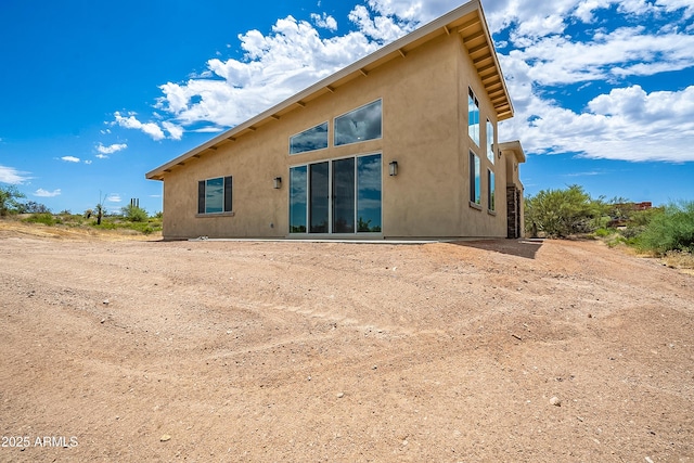 back of house featuring stucco siding