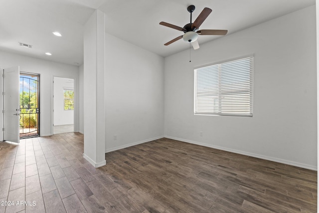 empty room featuring baseboards, ceiling fan, dark wood finished floors, and recessed lighting