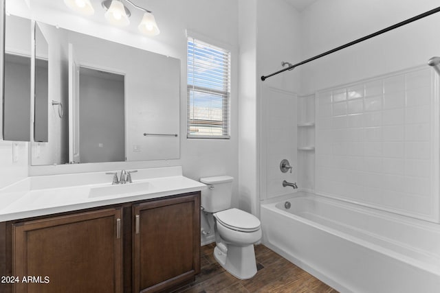 bathroom with bathing tub / shower combination, vanity, toilet, and wood finished floors