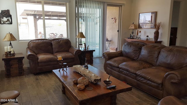 living area with baseboards and wood finished floors