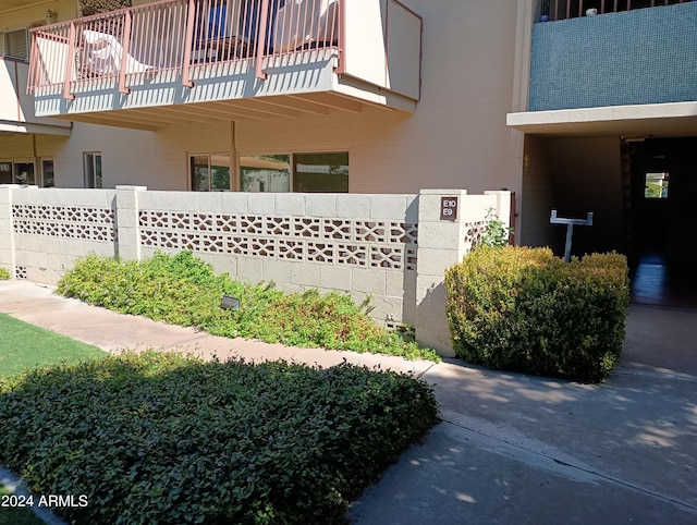 view of side of property with a balcony