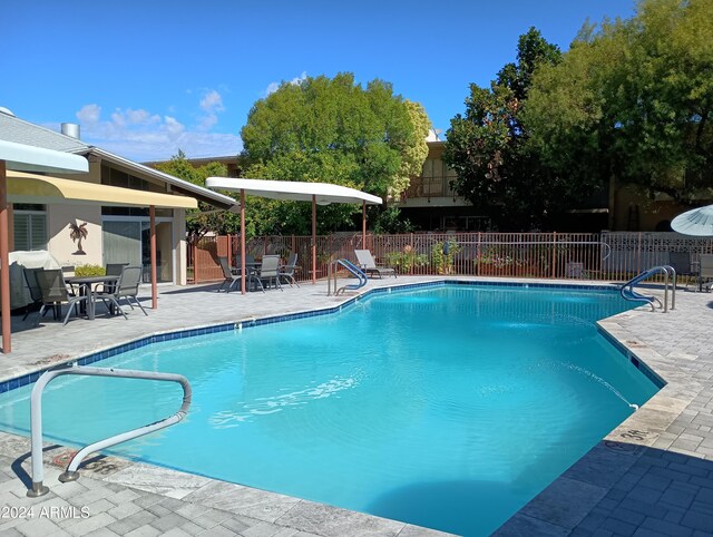 view of swimming pool with a patio