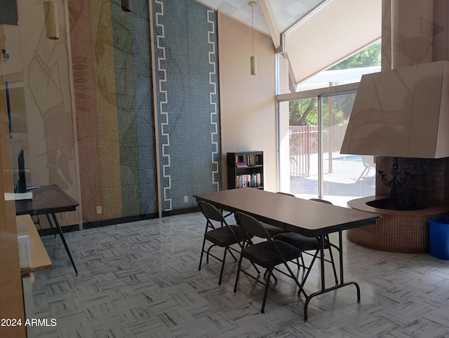 dining room with high vaulted ceiling and light parquet flooring